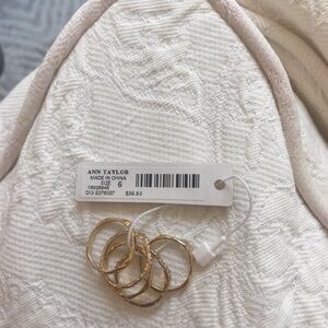 Set of 5 gold colored bands. Rings Size 6. NWT